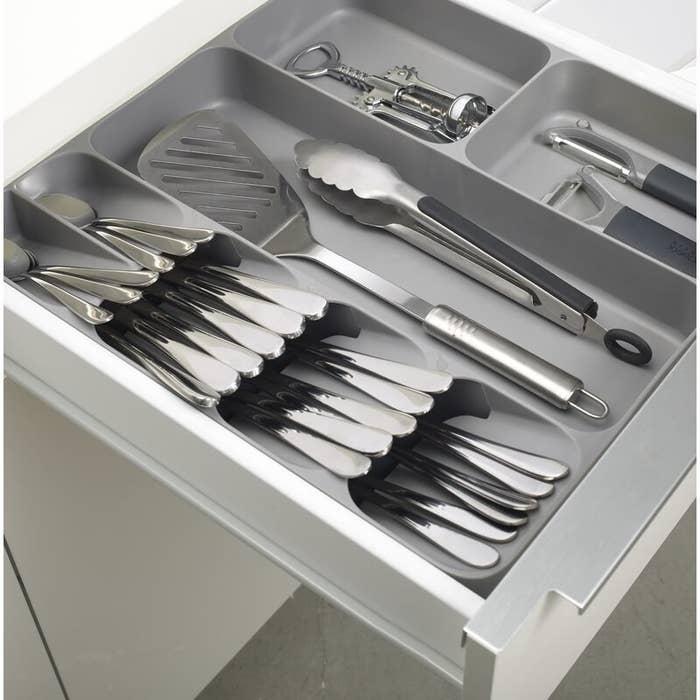 Stainless steel eating utensils inside a drawer
