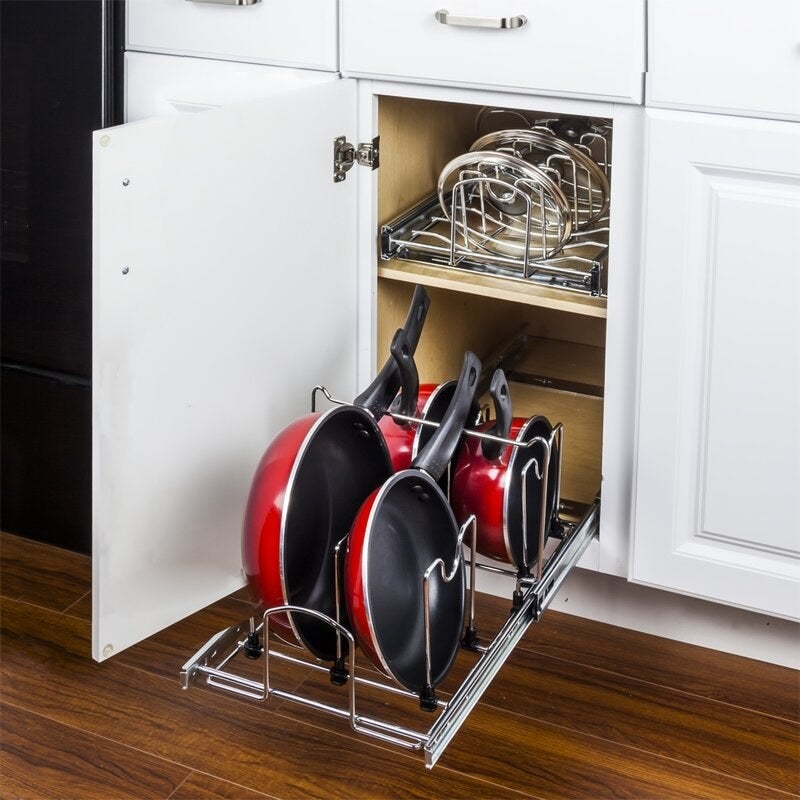 Pots and pans neatly organized inside a kitchen cabinet