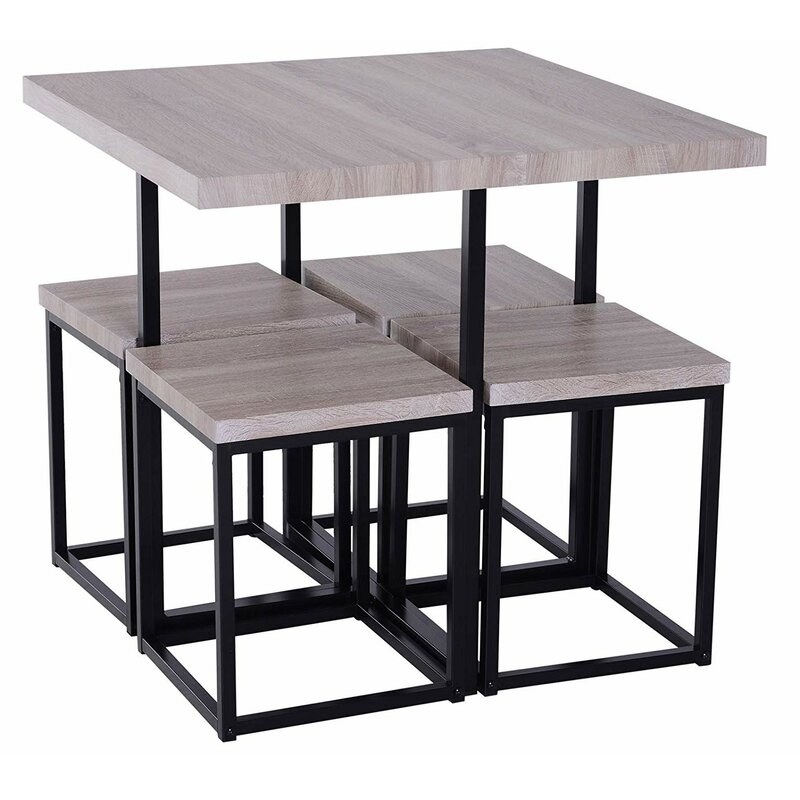 A gray and black square table with four bar stools