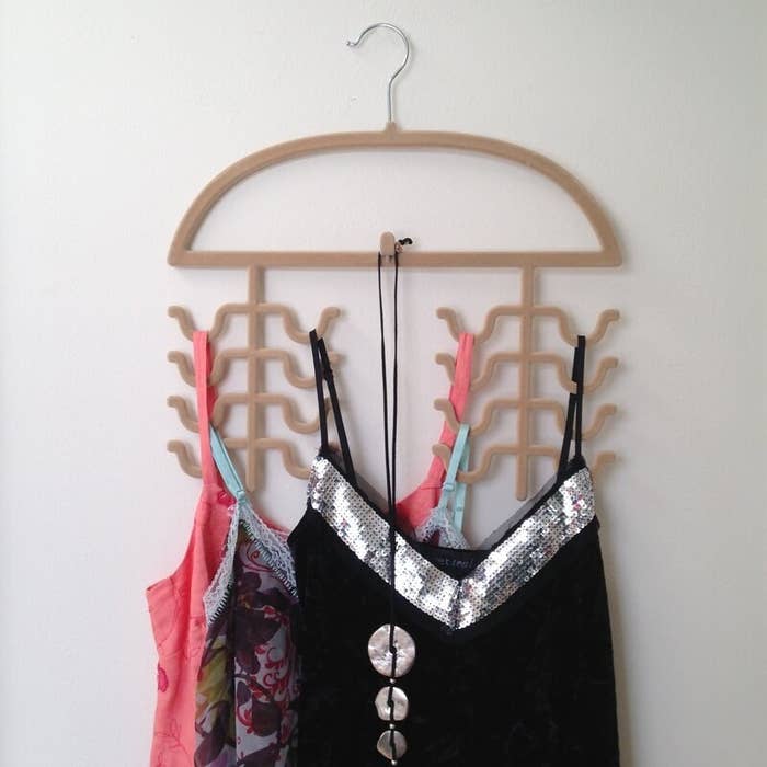 Three camisoles on a brown hanger