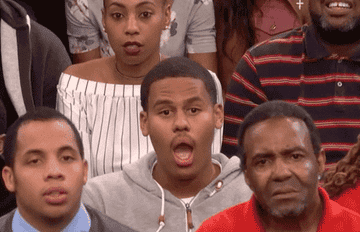 GIF of man in a talk show audience with his mouth open in shock