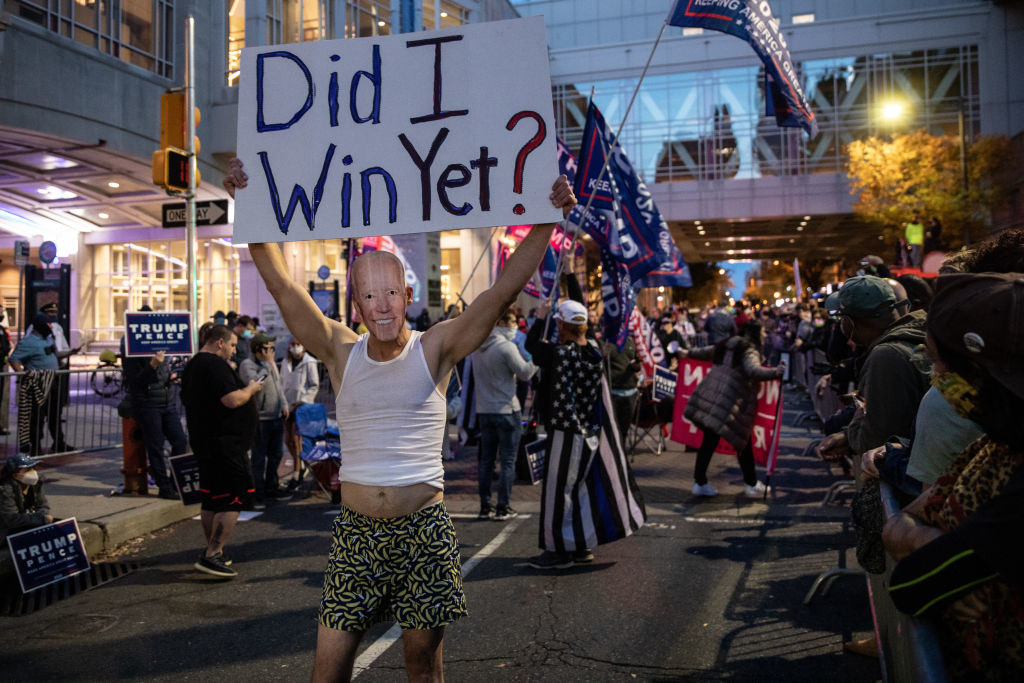 Man wearing Biden mask holds sign that says, &quot;Did I Win Yet?