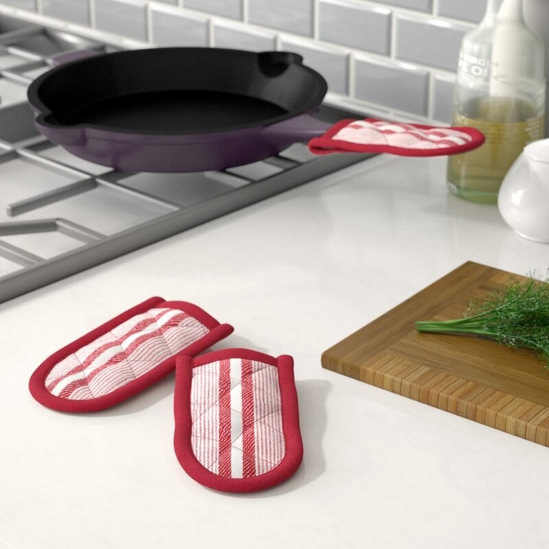 The red pan holders on the handle of a cast iron skillet