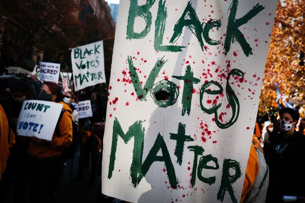 Biden supporter holding sign that says, &quot;Black Votes Matter&quot;