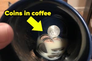 A coffee mug with coffee and coins at the bottom