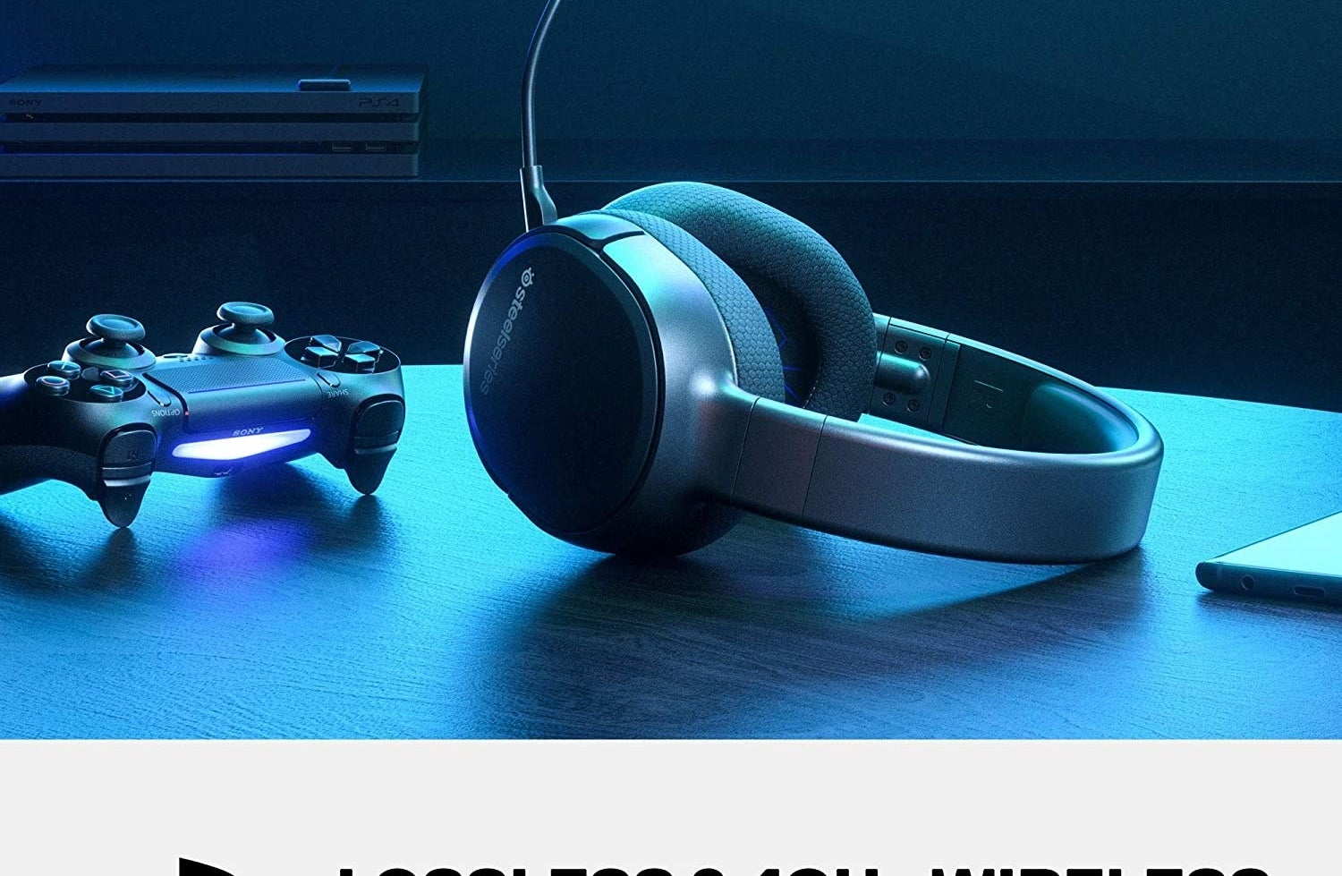 A wireless headset with microphone sits on a table near a game controller