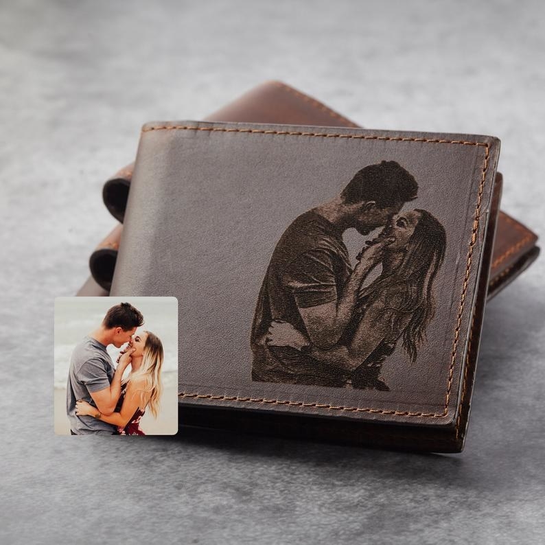 a leather wallet with a photo of a couple engraved on it