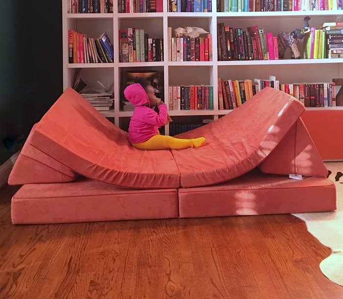 A child playing on a nugget couch