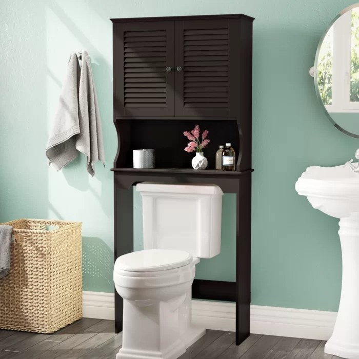 A black cabinet standing over the toilet