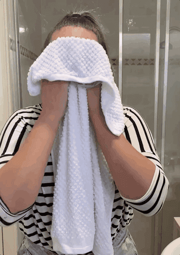 Writer wiping face with cold hand towel