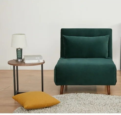 A green chair placed next to an end table