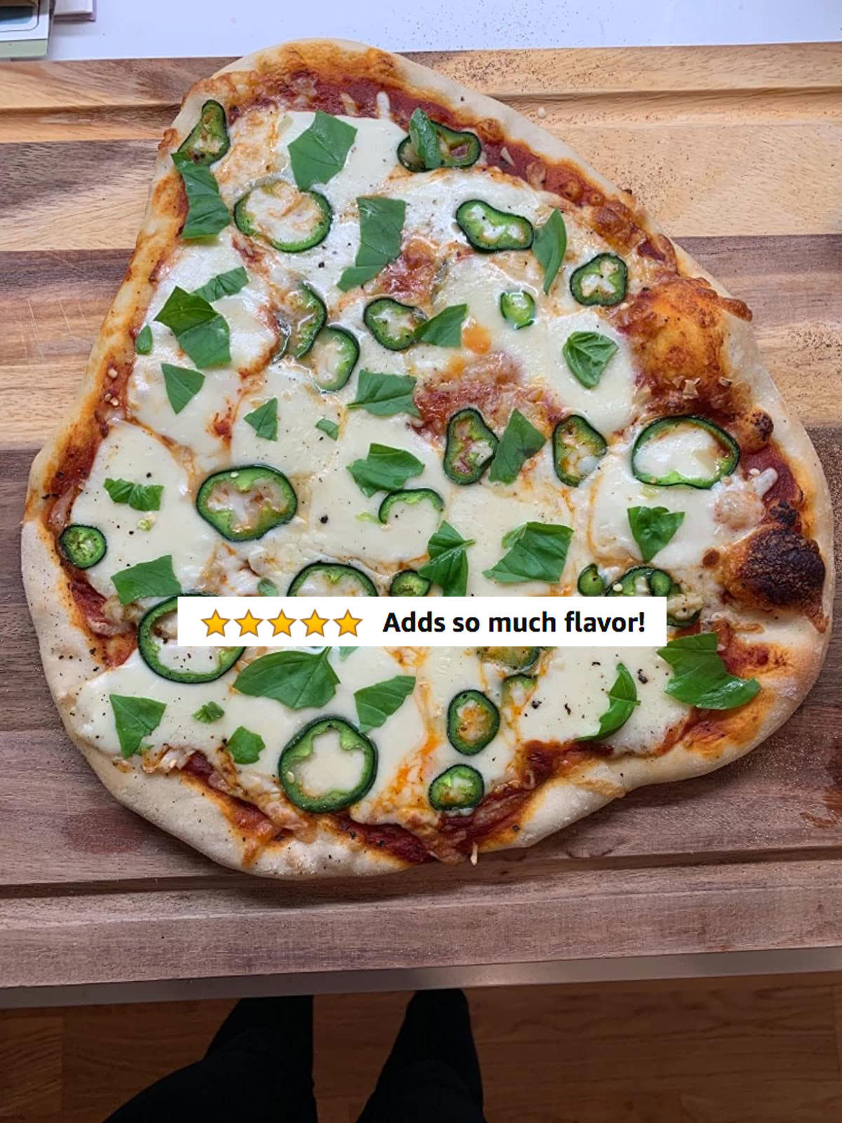 A reviewer&#x27;s finished pizza with five stars and text &quot;adds so much flavor&quot;
