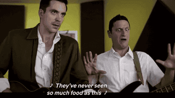 Gif of Tim Robinson from a sketch singing, &quot;They&#x27;ve never seen so much food&quot;