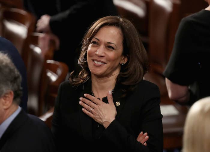 Kamala Harris smiling with her hand over her heart