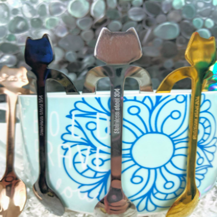 the spoons hanging on a coffee mug