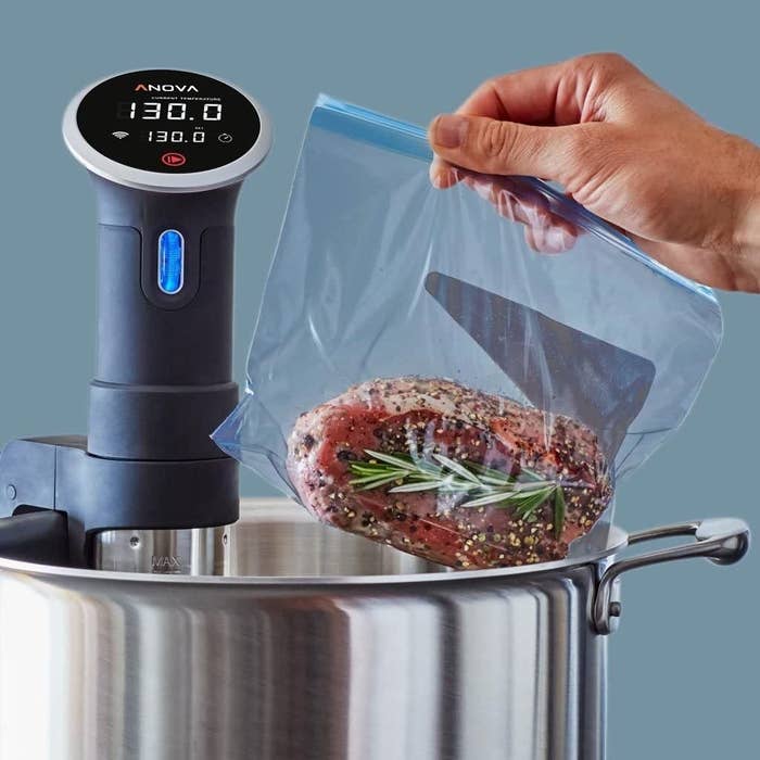 Meat, marinated in a plastic bag, being placed into a sous vide precision cooker