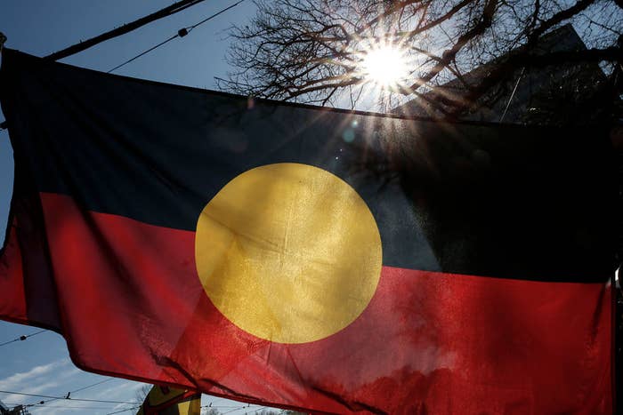 The Aboriginal Flag is seen flying during a NAIDOC march.