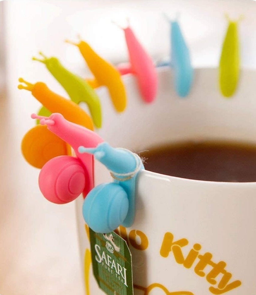 tea mug with the snail shape holders on the edge to tie your tea bag string around
