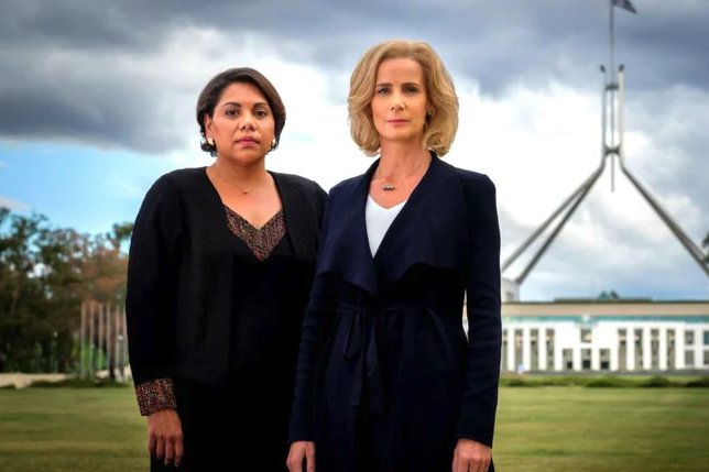 Rachel Griffiths and Deborah Mailman as their characters in &quot;Total Control&quot;; they&#x27;re standing on the lawn of Parliament House, in Canberra