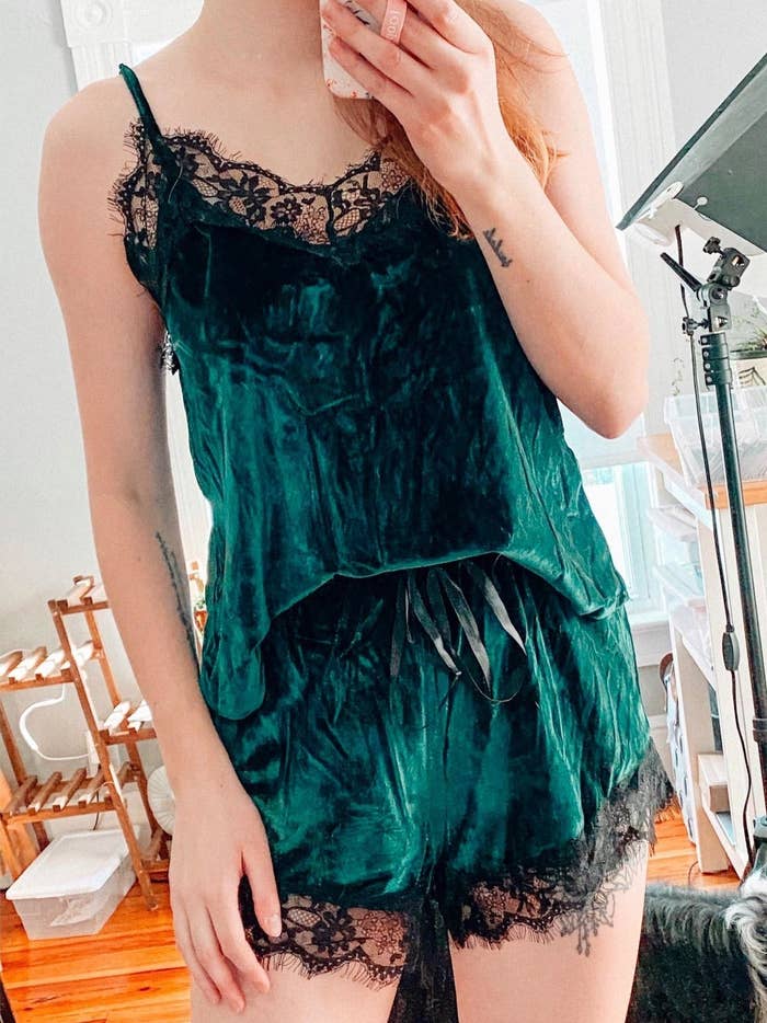 A reviewer in the green velvet tank and shorts set with black lace