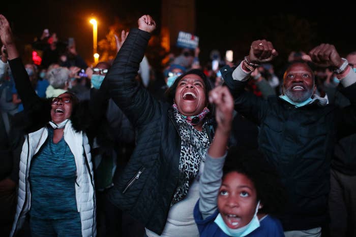 Jailyn Banks and King M (C-R) and others celebrate as President-elect Joe Biden arrives on stage at the Chase Center to address the nation on November 07, 2020 in Wilmington, Delaware