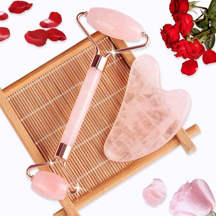 A rose quartz face roller and gua sha 