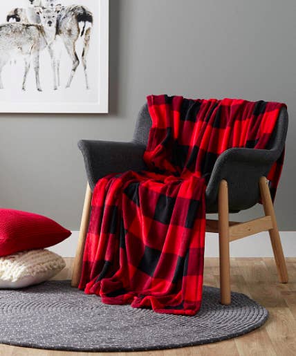 A large fluffy blanket draped over a small armchair