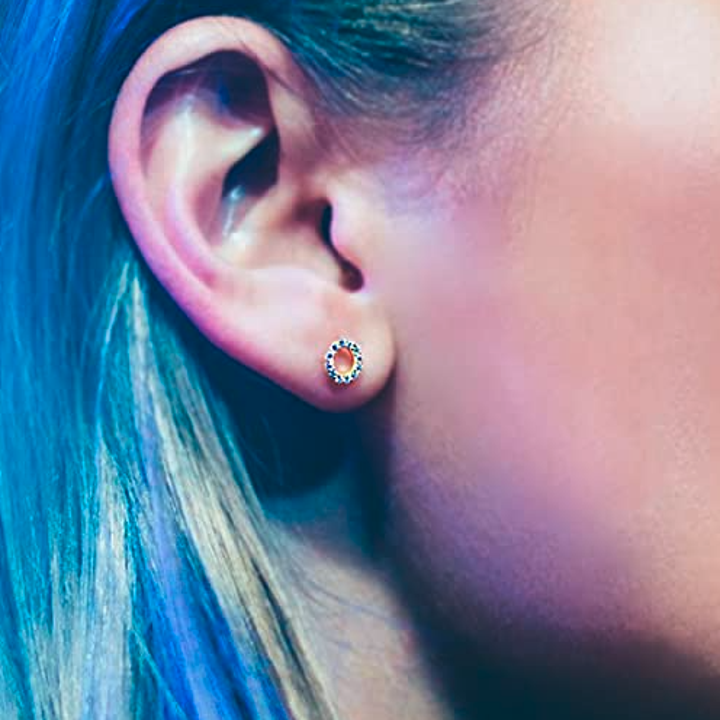 Close up of the circular earrings that have little cubic zirconias in them