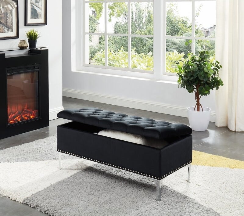 The black bench with metal studs on the bottom