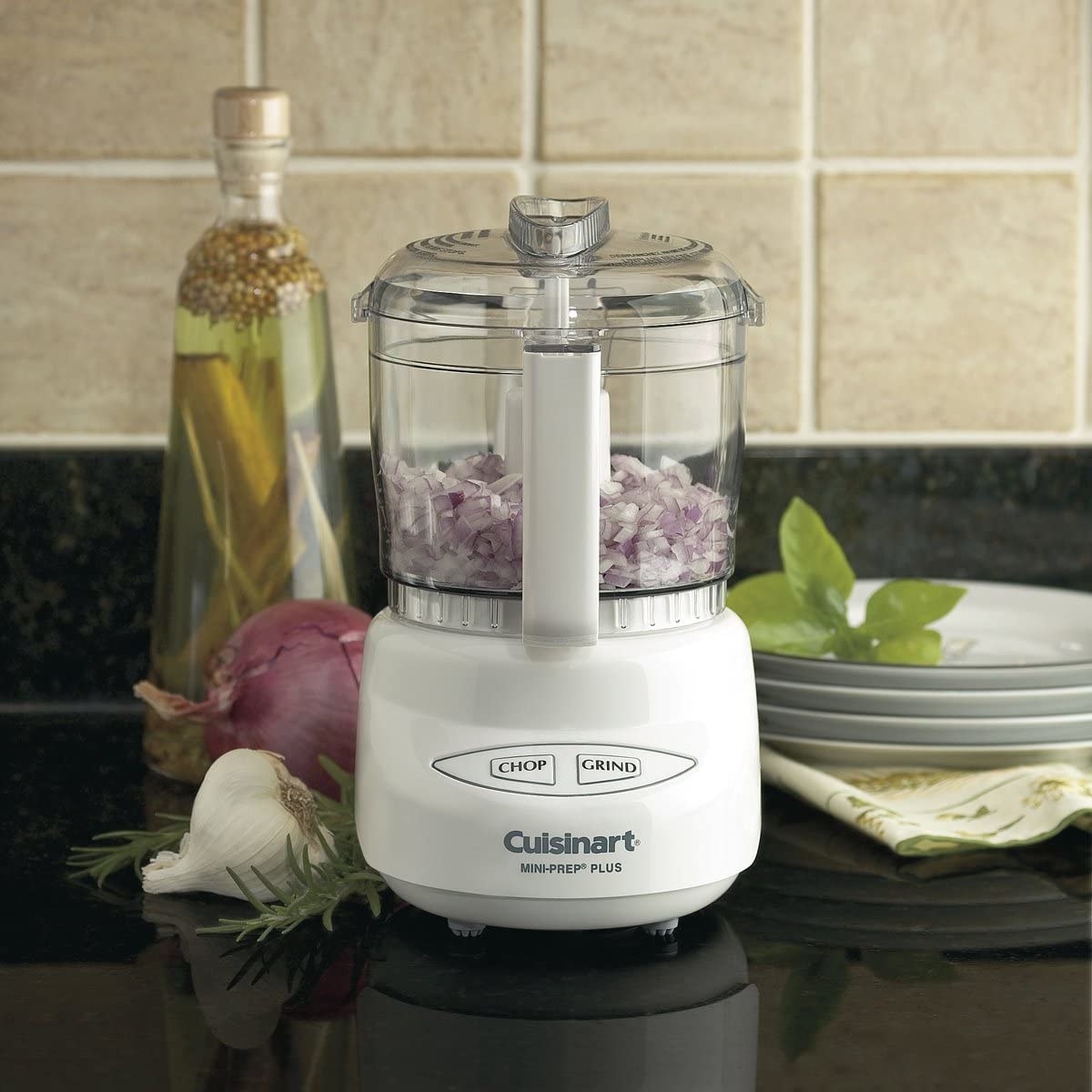 A food processor filled with diced onions