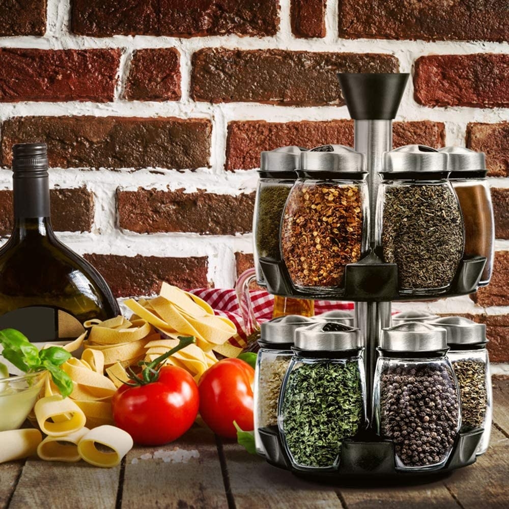 A spice rack on a table beside food