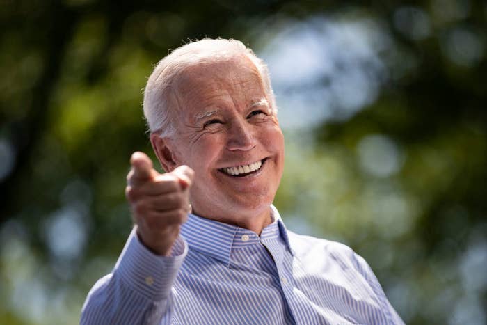 Joe Biden pointing with a huge smile on his face