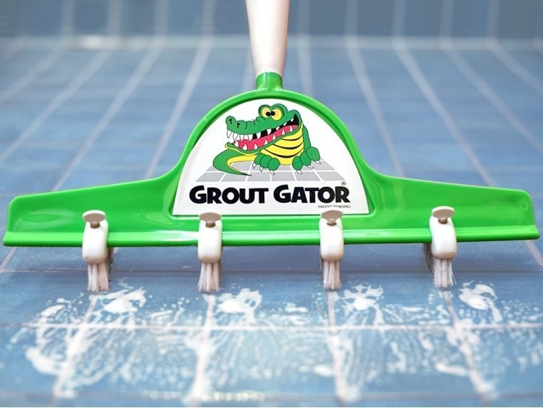 the broom-like tool with four brushes on it that line up with the tile grout lines