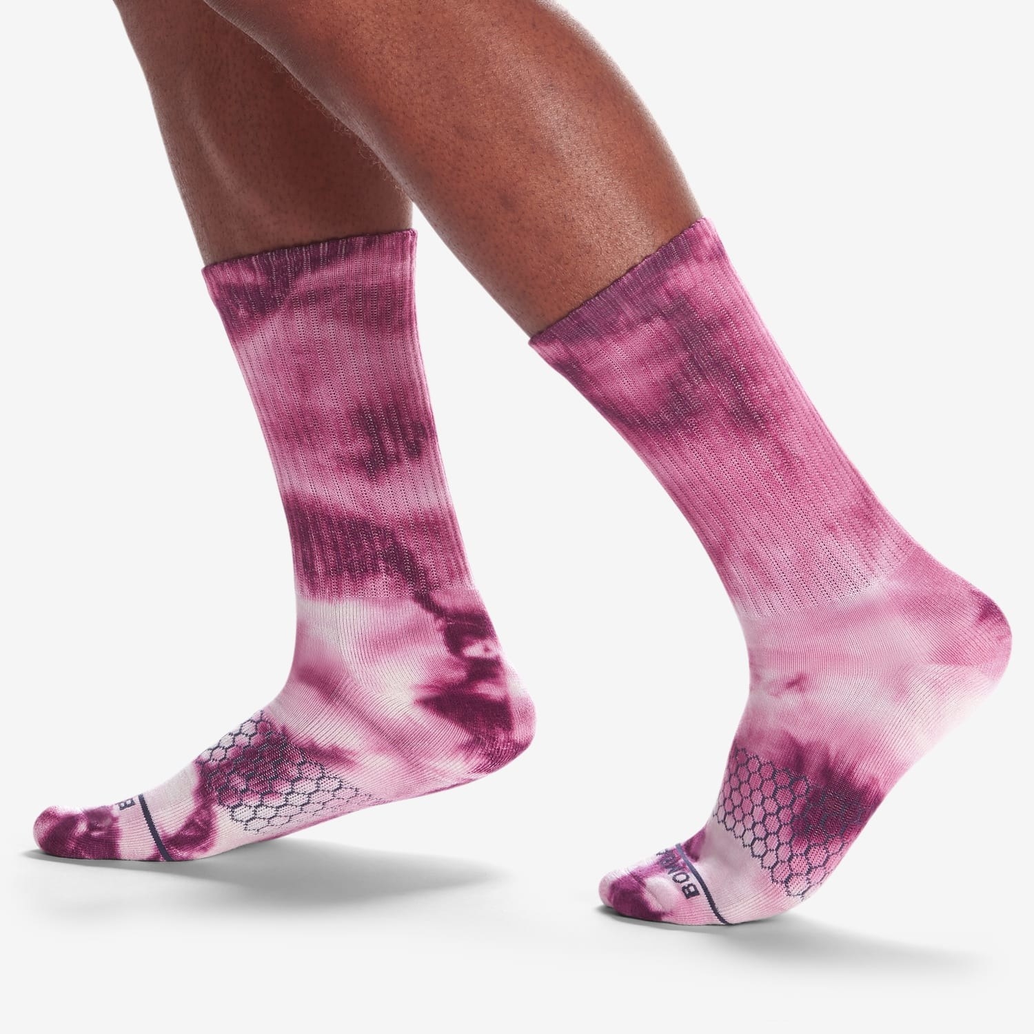 a model wearing pink tye dye socks 