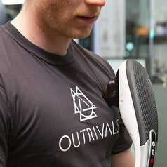 A person uses the massager on their chest