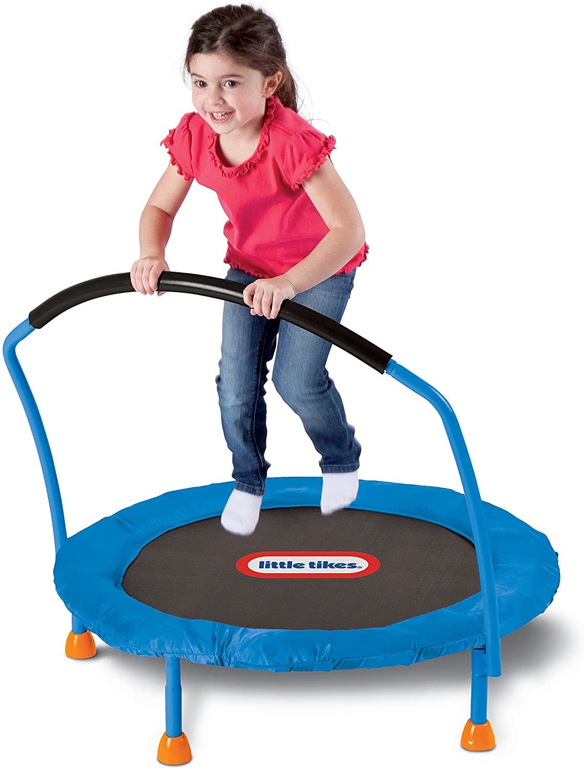 A young child bounces on a trampoline.