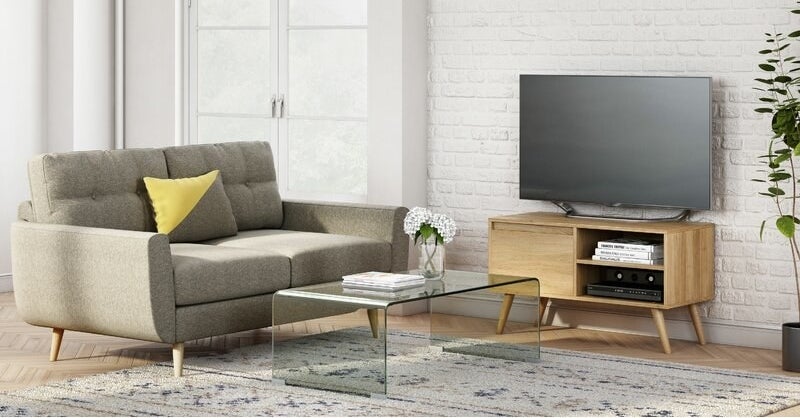 A clear plastic coffee table in the center of a living room
