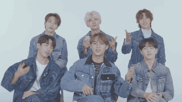 The members of Seventeen making animated gestures