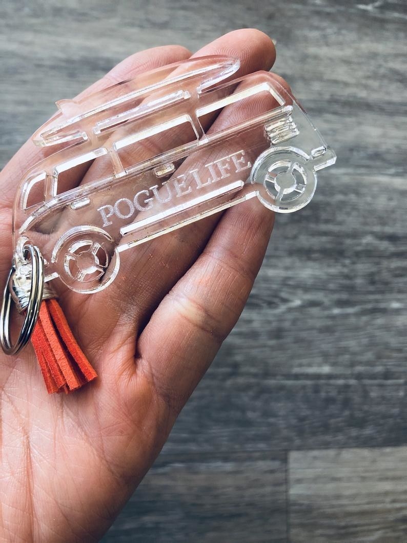 the laser cut pogue life keychain in the palm of a hand