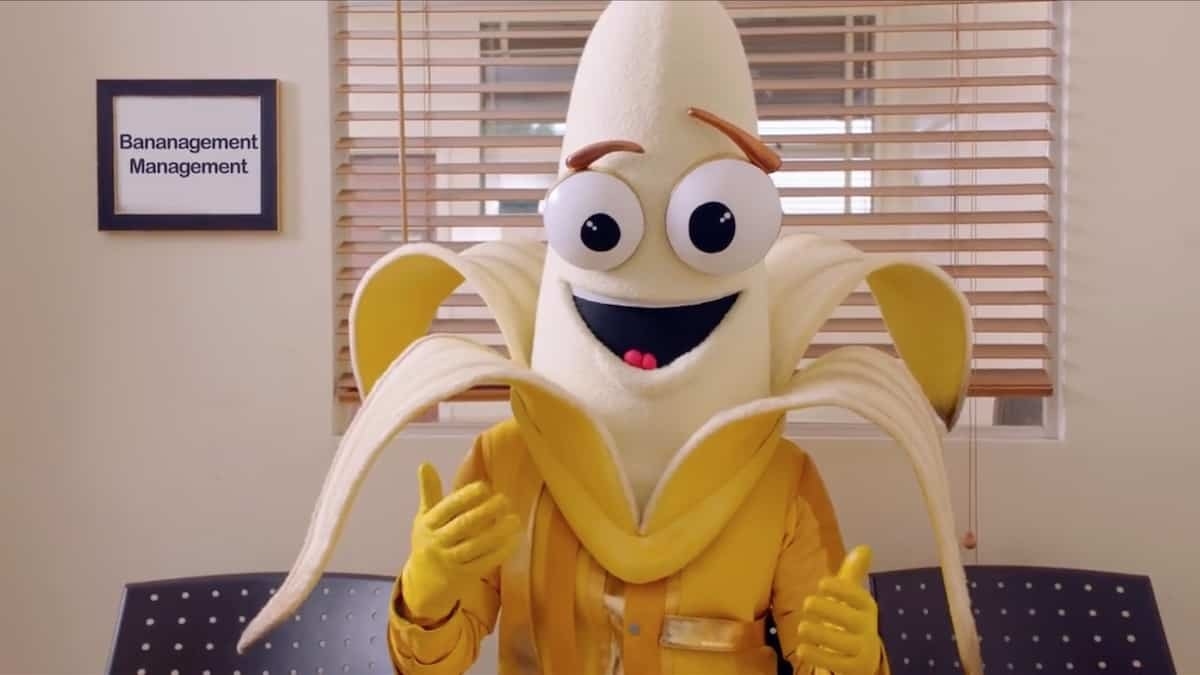 Contestant in a smiling peeled banana costume with expressive eyes