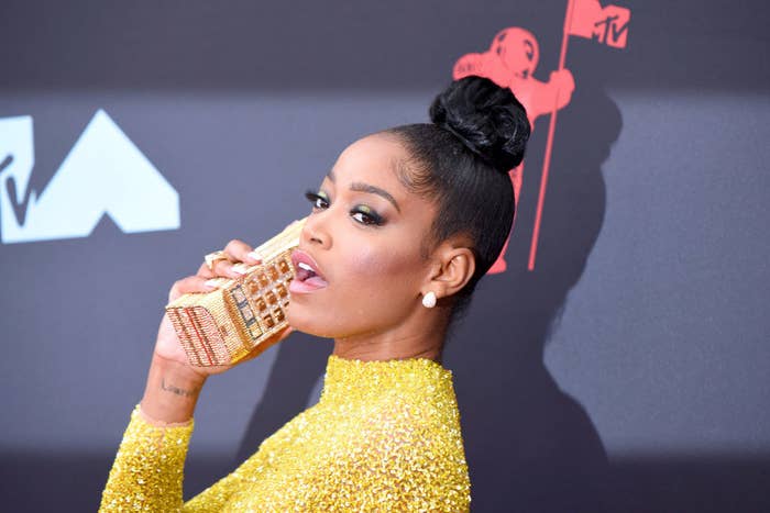 Keke holding a phone-shaped clutch to her ear as she poses at the 2020 MTV VMAs