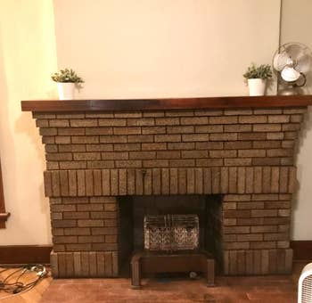 A customer review photo of their clean fireplace mantel (no soot stains) after using the fireplace cleaner