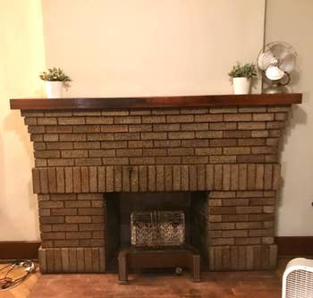 A customer review photo of their clean fireplace mantel (no soot stains) after using the fireplace cleaner