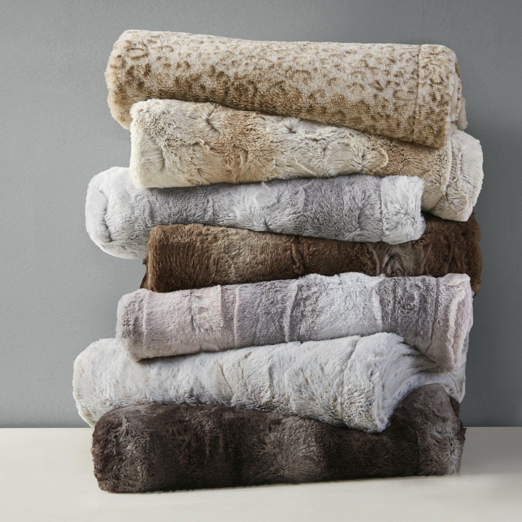Stack of faux-fur throws