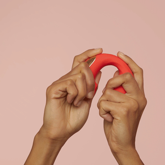 Gif of hands moving massager up and down, showing curving ability 