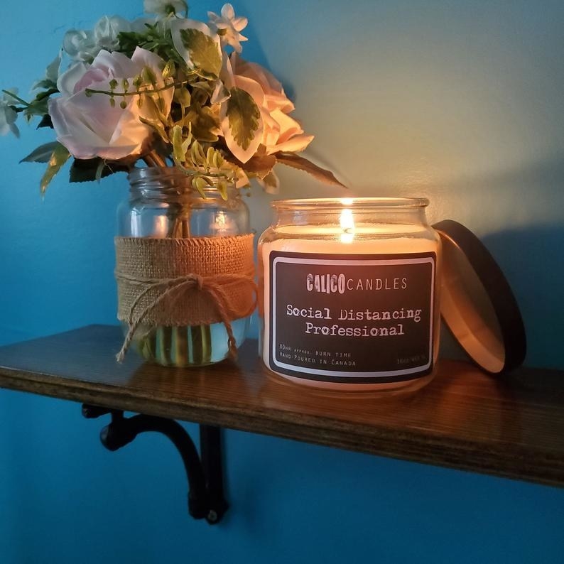 A candle that says social distancing professional