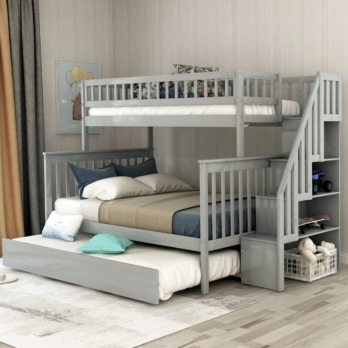 Light gray bunk bed with trundle, and blue, brown and white bedding