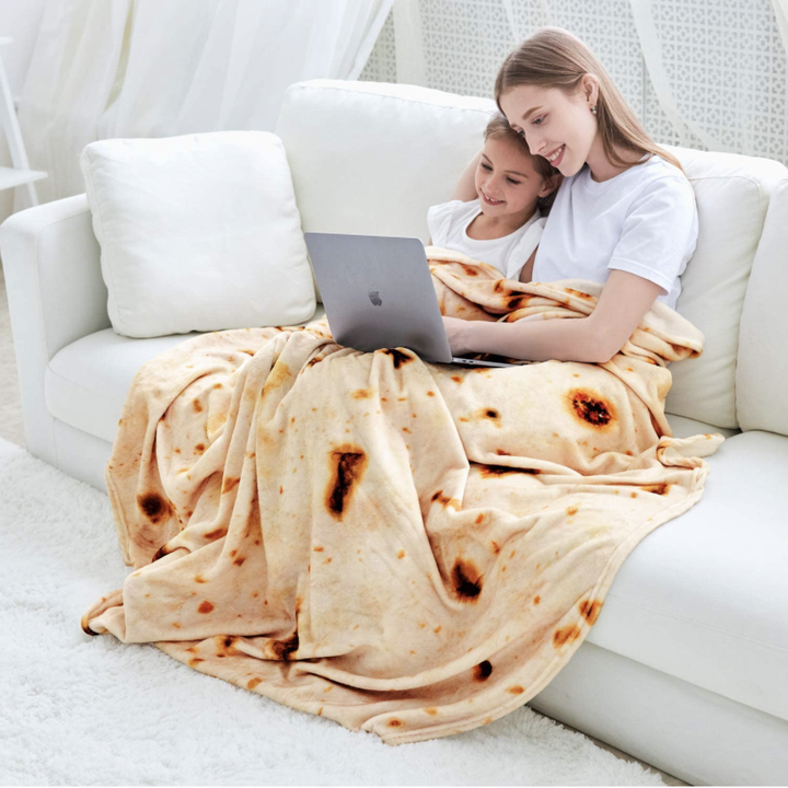 A blanket that is round and made to look like a burrito tortilla