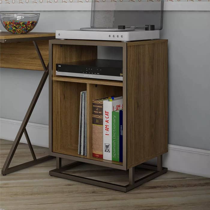 The stand holding a record player and several records