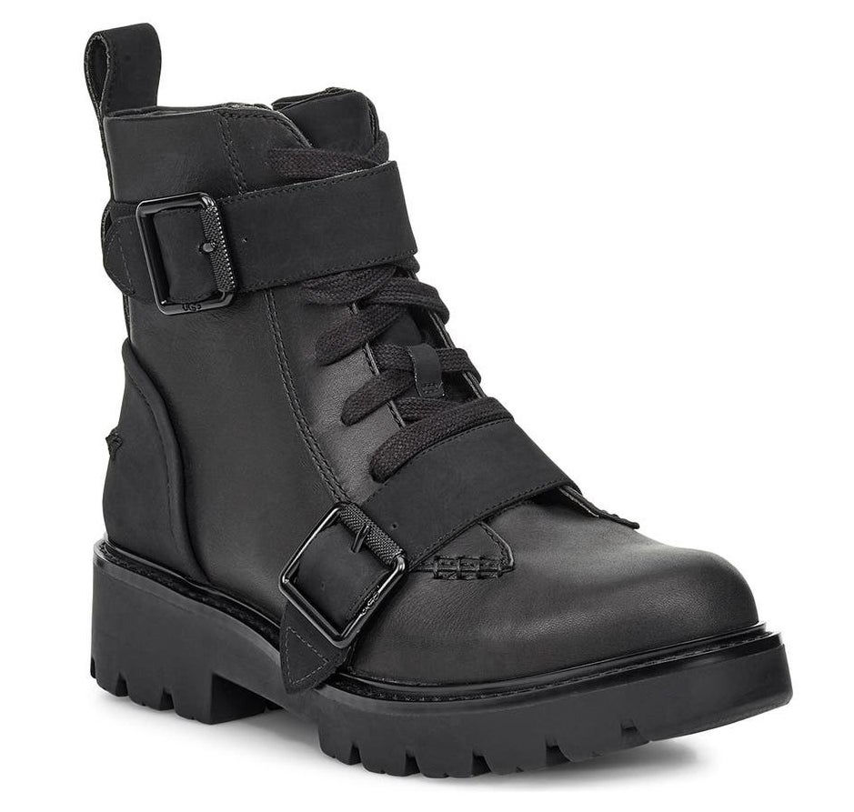 The black leather boots with roller-buckle straps and a chunky lug sole